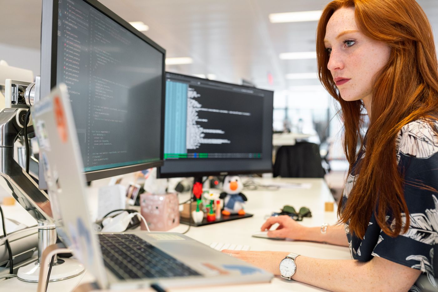 IT consultant working at a multi-monitor workstation